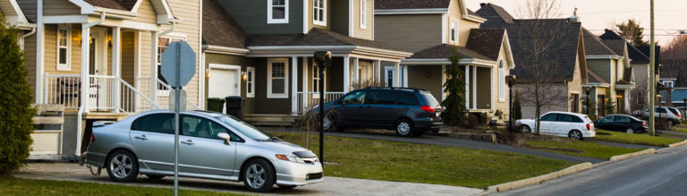 Carsparked in residential neighborhood driveways