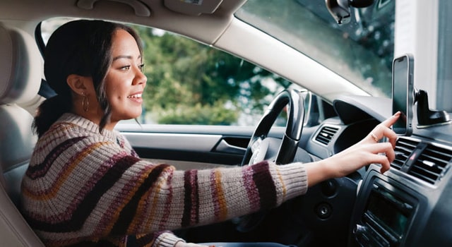 woman in car using phone