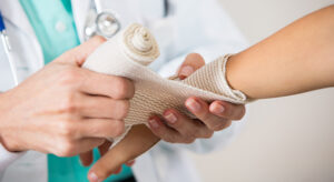 A doctor bandaging a patient’s wrist