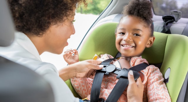 parent buckling in child in a car seat covered by insurance