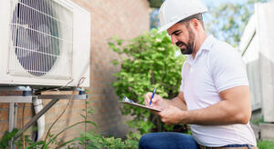 Home inspector writing notes on clipboard