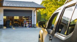 SUV parked in driveway in front of open garage